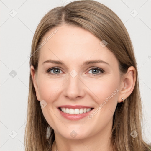 Joyful white young-adult female with long  brown hair and grey eyes