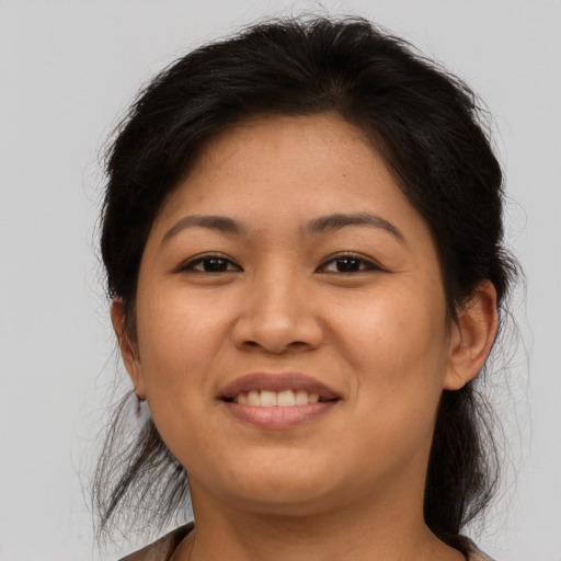 Joyful asian young-adult female with medium  brown hair and brown eyes