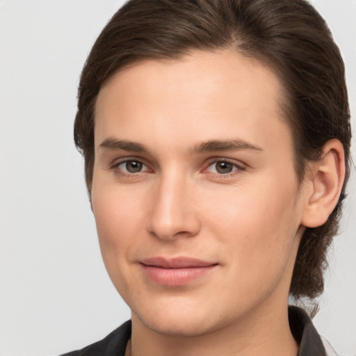 Joyful white young-adult female with medium  brown hair and brown eyes