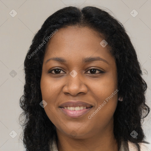 Joyful black young-adult female with long  brown hair and brown eyes