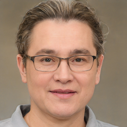 Joyful white adult male with short  brown hair and grey eyes