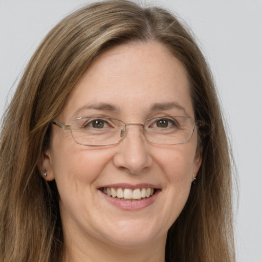 Joyful white adult female with long  brown hair and green eyes