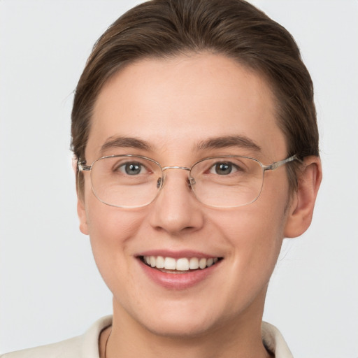 Joyful white young-adult female with short  brown hair and grey eyes