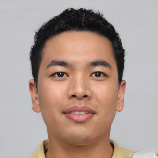 Joyful asian young-adult male with short  black hair and brown eyes