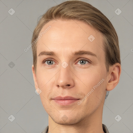 Joyful white young-adult male with short  brown hair and grey eyes