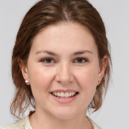 Joyful white young-adult female with medium  brown hair and grey eyes