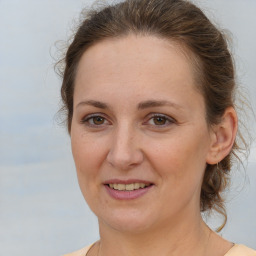 Joyful white adult female with medium  brown hair and brown eyes