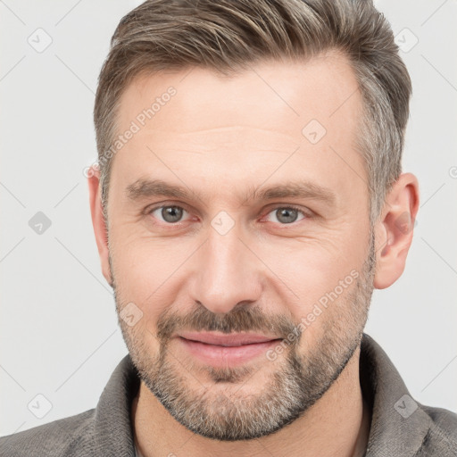 Joyful white adult male with short  brown hair and grey eyes