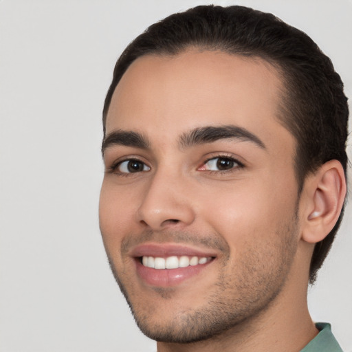 Joyful white young-adult male with short  brown hair and brown eyes