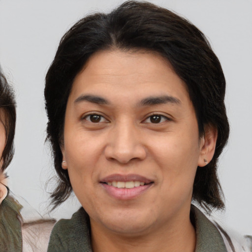 Joyful white adult female with medium  brown hair and brown eyes