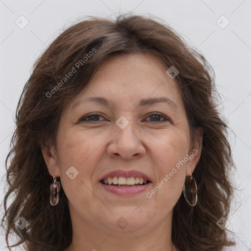 Joyful white adult female with long  brown hair and grey eyes