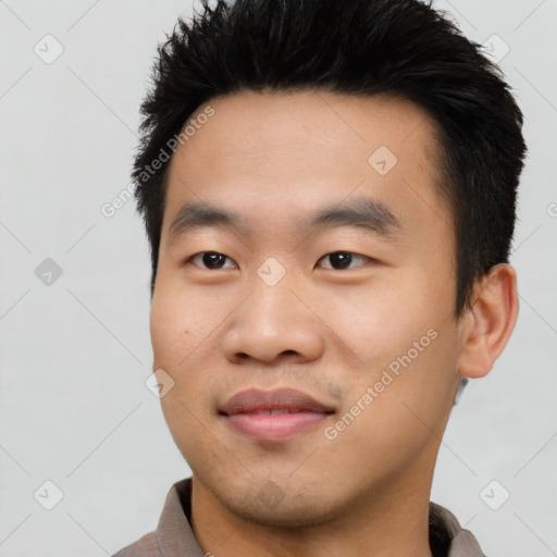 Joyful asian young-adult male with short  black hair and brown eyes