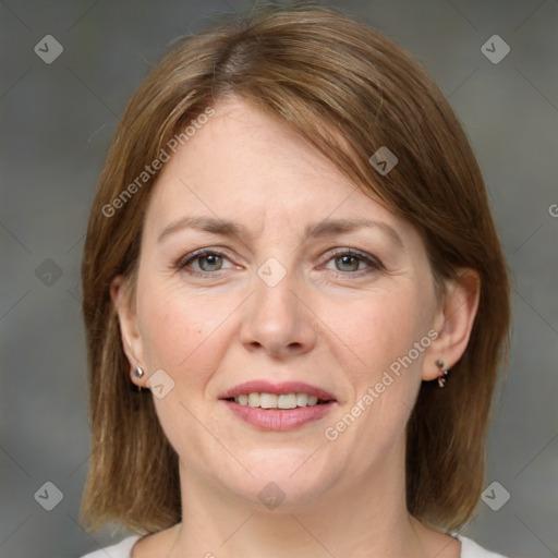 Joyful white adult female with medium  brown hair and grey eyes