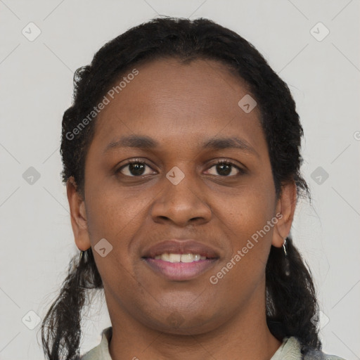 Joyful black young-adult female with short  black hair and brown eyes