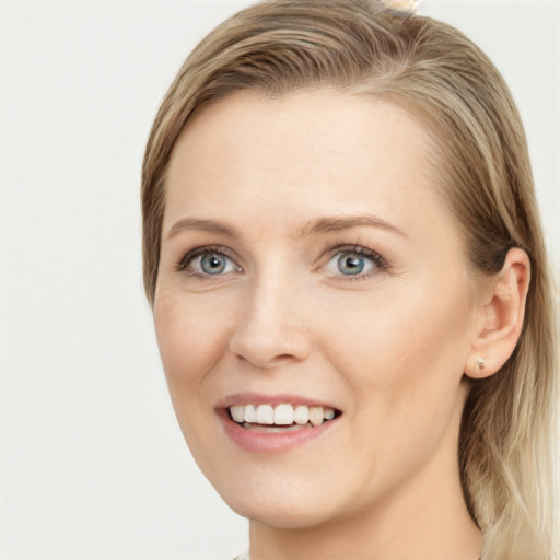 Joyful white young-adult female with long  brown hair and blue eyes