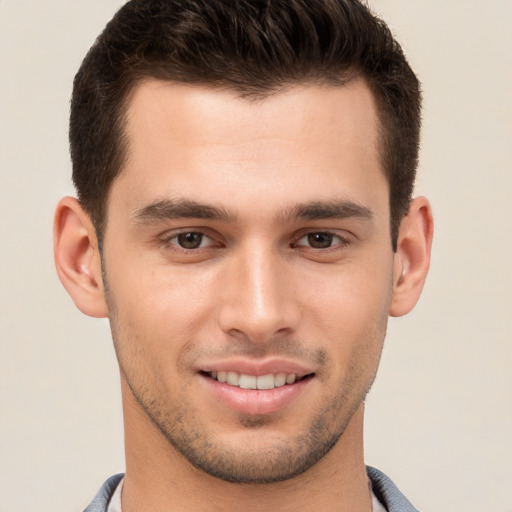 Joyful white young-adult male with short  brown hair and brown eyes