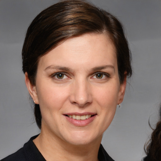 Joyful white adult female with medium  brown hair and brown eyes