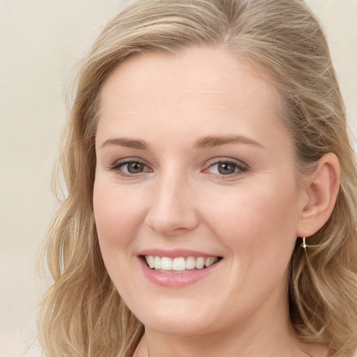 Joyful white young-adult female with long  brown hair and blue eyes