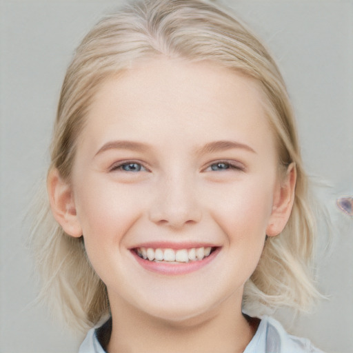 Joyful white child female with medium  blond hair and blue eyes