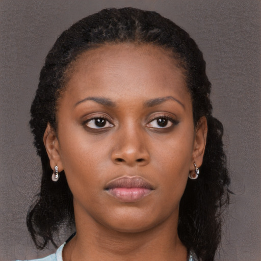 Neutral black young-adult female with long  brown hair and brown eyes
