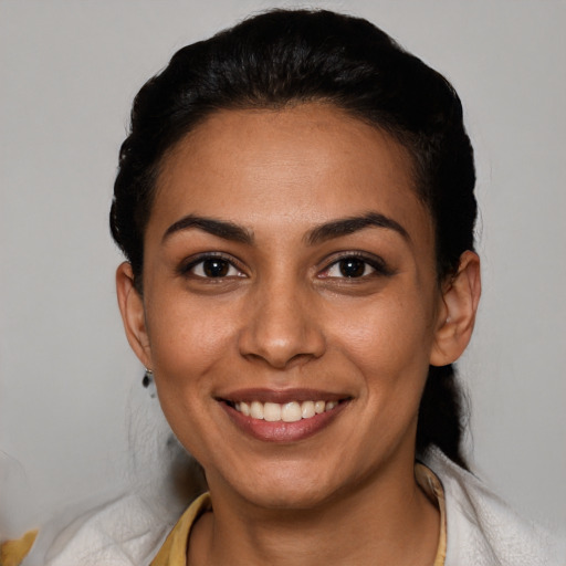 Joyful latino young-adult female with short  black hair and brown eyes