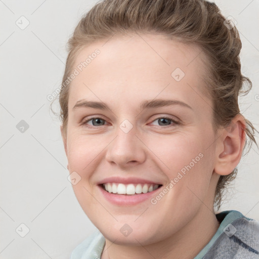 Joyful white young-adult female with medium  brown hair and blue eyes