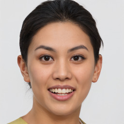 Joyful asian young-adult female with short  brown hair and brown eyes