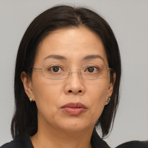 Joyful asian adult female with medium  brown hair and brown eyes