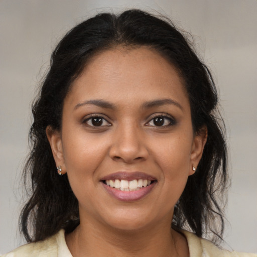 Joyful latino young-adult female with medium  brown hair and brown eyes