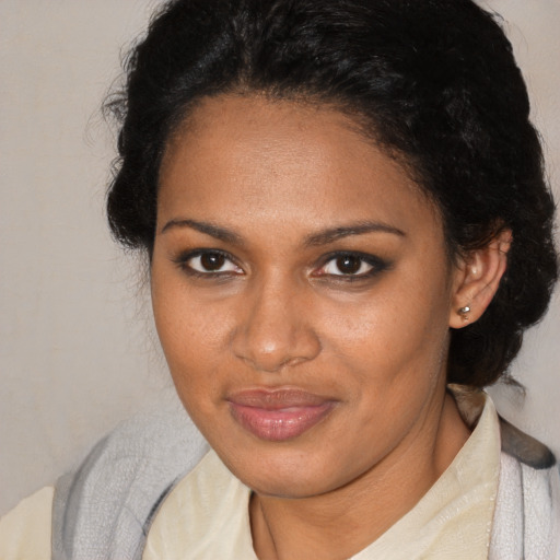 Joyful black young-adult female with medium  brown hair and brown eyes