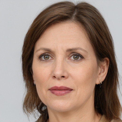 Joyful white adult female with medium  brown hair and grey eyes