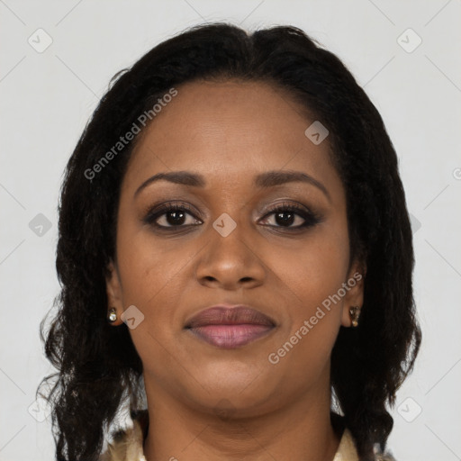 Joyful black adult female with long  brown hair and brown eyes
