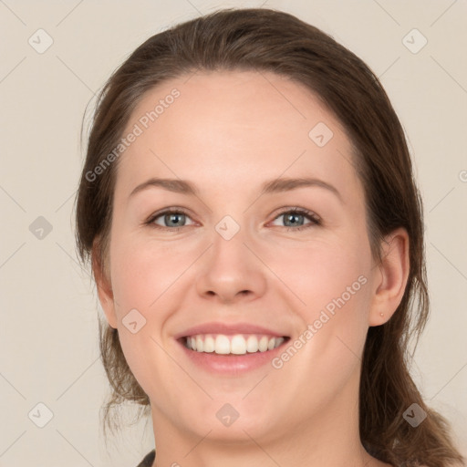 Joyful white young-adult female with medium  brown hair and green eyes