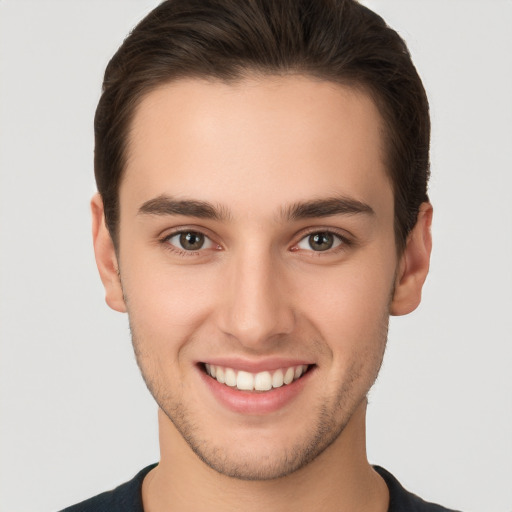 Joyful white young-adult male with short  brown hair and brown eyes