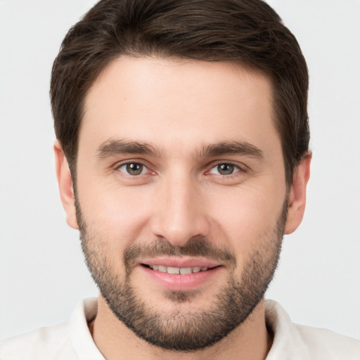 Joyful white young-adult male with short  brown hair and brown eyes