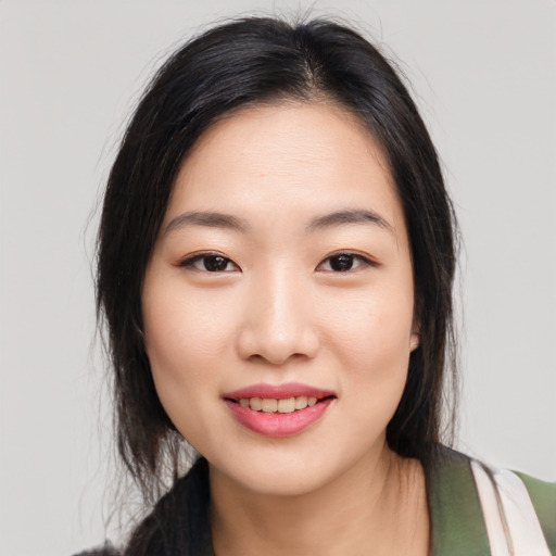 Joyful asian young-adult female with medium  black hair and brown eyes