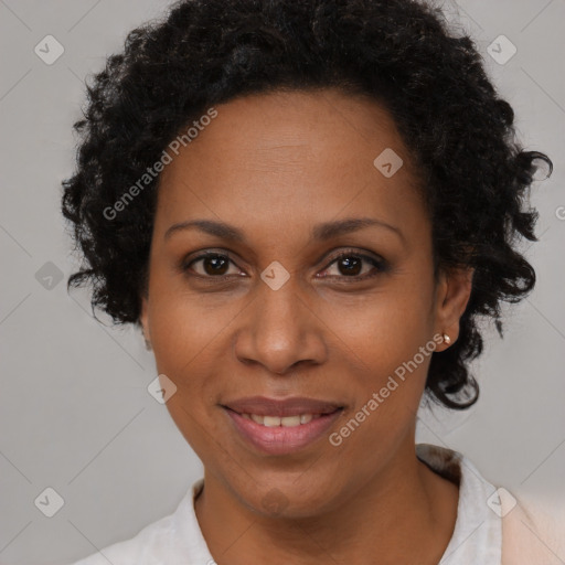 Joyful black adult female with short  brown hair and brown eyes