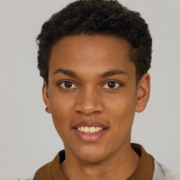 Joyful black young-adult male with short  brown hair and brown eyes