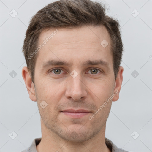 Joyful white young-adult male with short  brown hair and brown eyes