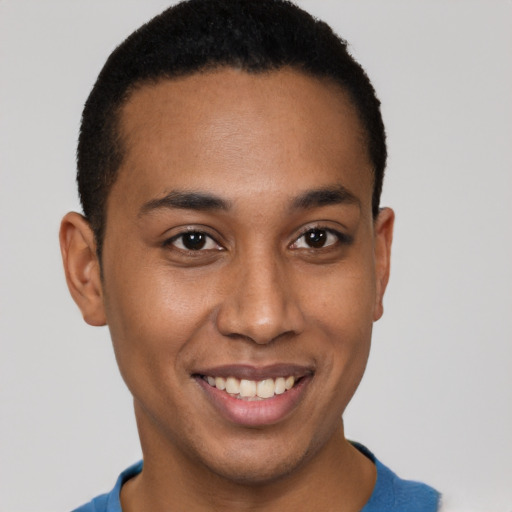 Joyful latino young-adult male with short  brown hair and brown eyes