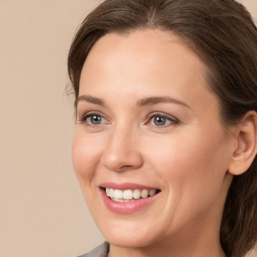 Joyful white young-adult female with medium  brown hair and brown eyes