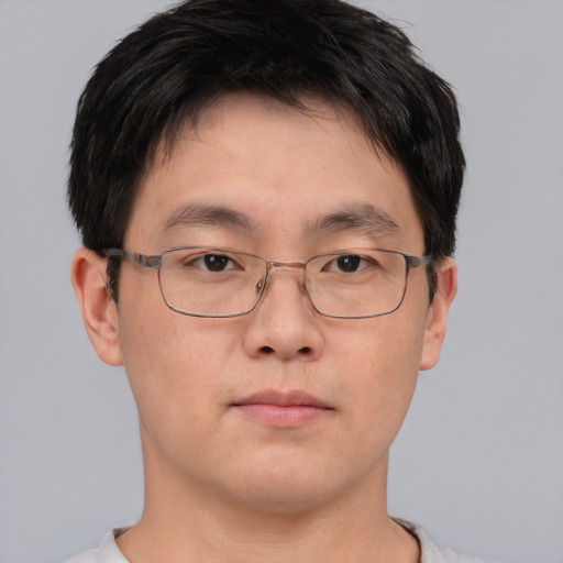 Neutral asian adult male with short  brown hair and brown eyes