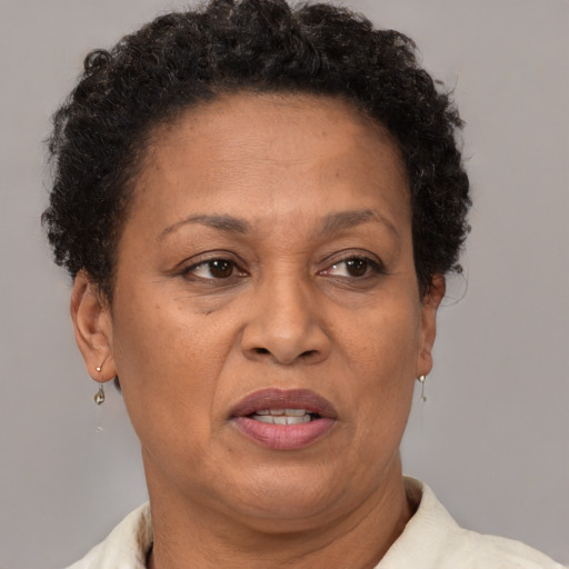 Joyful black adult female with short  brown hair and brown eyes