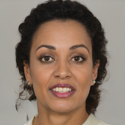 Joyful black young-adult female with medium  brown hair and brown eyes