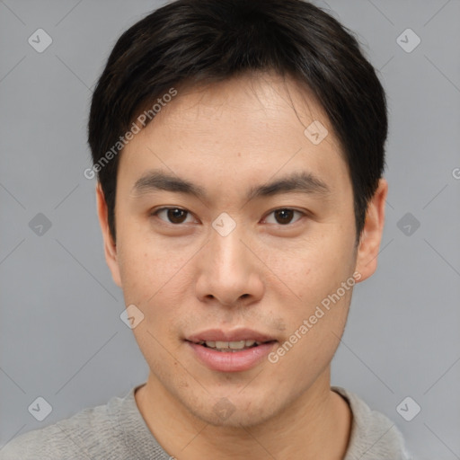 Joyful asian young-adult male with short  brown hair and brown eyes