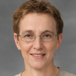 Joyful white adult female with short  brown hair and grey eyes