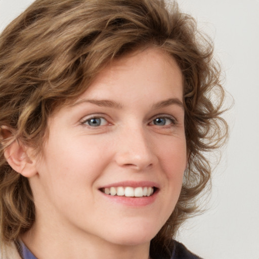 Joyful white young-adult female with medium  brown hair and blue eyes