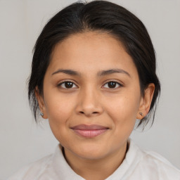 Joyful latino young-adult female with medium  brown hair and brown eyes