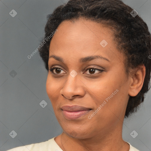 Joyful black young-adult female with short  brown hair and brown eyes