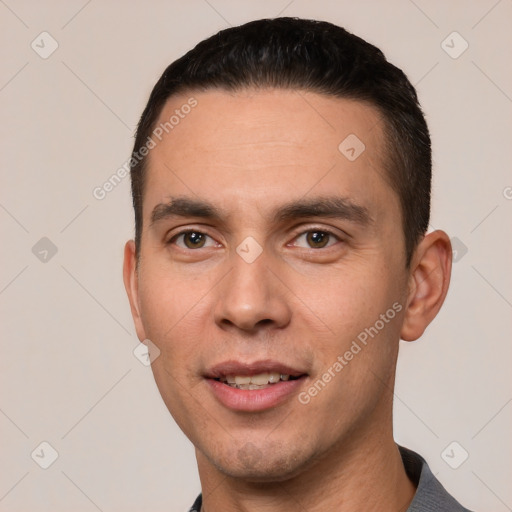 Joyful white young-adult male with short  black hair and brown eyes